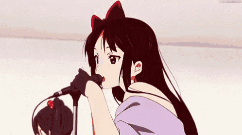 a girl in a purple shirt is singing into a microphone