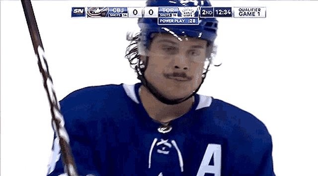 a hockey player wearing a blue jersey that says a on it