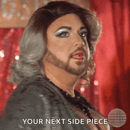 a drag queen with a beard and wig says " your next side piece "