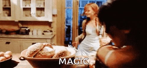 a woman in a white dress is standing in a kitchen next to a bowl of bread and a bowl of eggs .