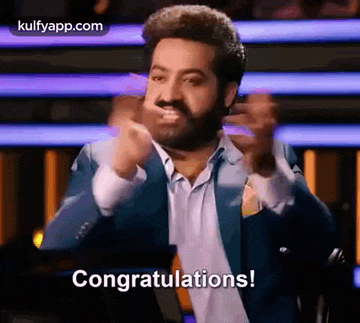 a man in a suit and tie is giving a congratulations speech .