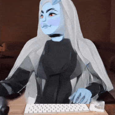 a person with a blue face is sitting at a table with a keyboard