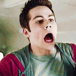 a young man with his mouth open is making a surprised face .