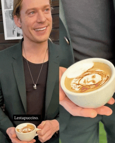 a man in a suit is holding a cup of coffee with a face drawn on it