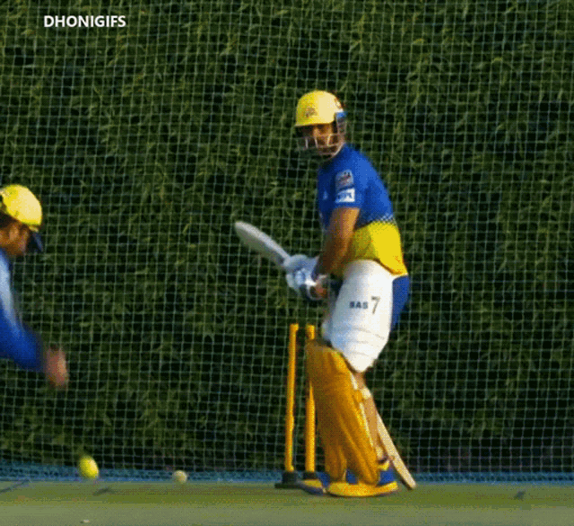 a cricket player wearing a blue and yellow uniform with the number 7 on it
