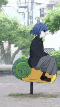 a girl with blue hair is sitting on a yellow and green carousel