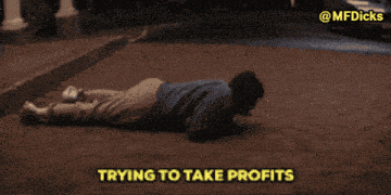 a man laying on the ground with the words trying to take profits