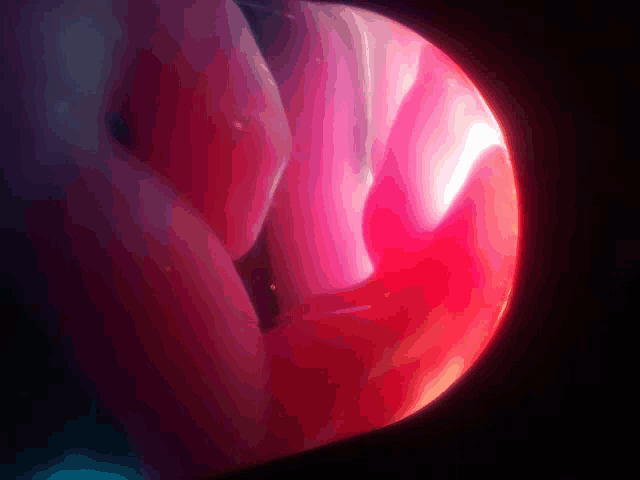 a close up of a red sphere with a dark background