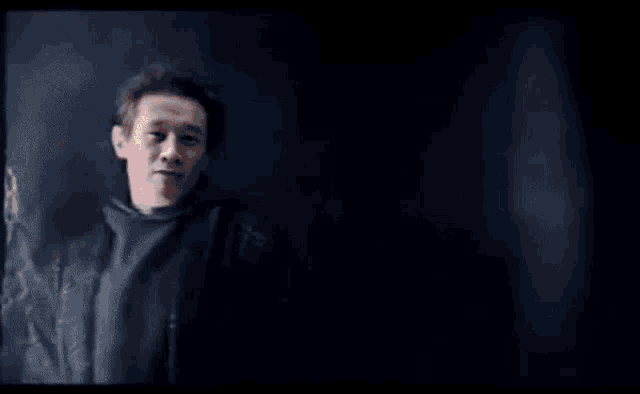 a man in a black jacket stands in front of a black background with the words you know im something of gamers myself