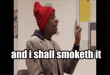 a man wearing a red beanie and a suit says " and i shall smoketh it "