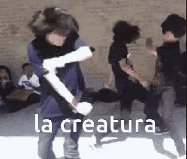a group of people are dancing in front of a brick wall and the words la creature are on the bottom