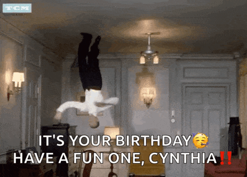 a man is hanging upside down in a room with the words it 's your birthday have a fun one cynthia