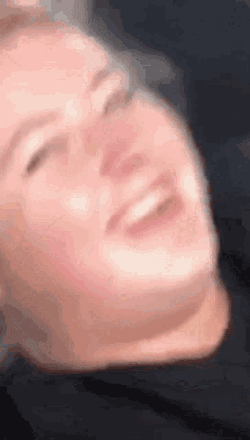 a blurry picture of a person 's face with their eyes closed