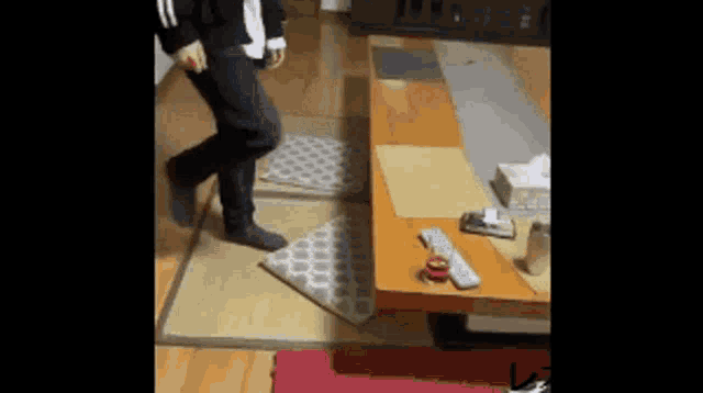 a person is standing on a rug in front of a table