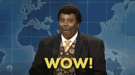 a man in a suit and tie is standing in front of a map with the word wow written on it .