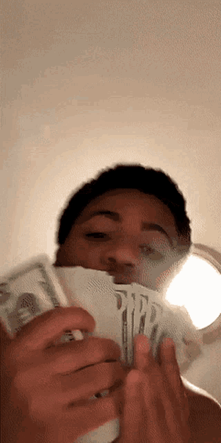 a man holding a bunch of money in his hands