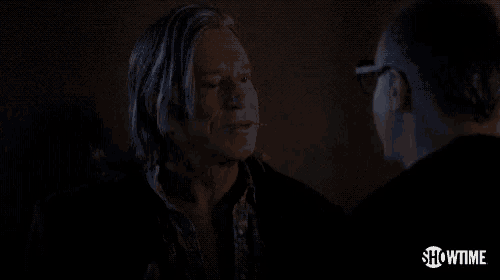 a man and a woman are talking in a dark room and the man says a deal 's a deal .