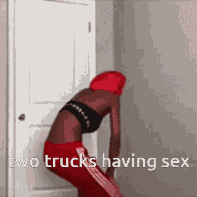 a woman in a red hat is standing in front of a door with the words two trucks having sex below her .