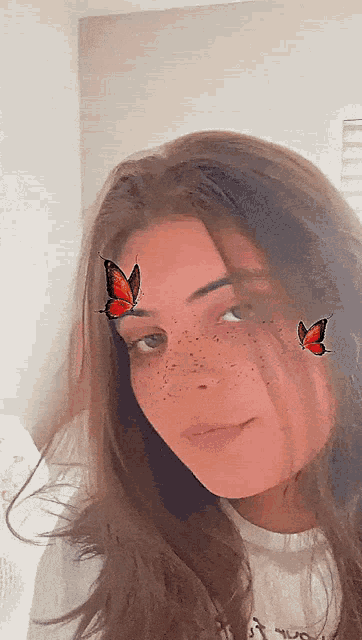 a girl with butterflies on her face is wearing a white shirt that says hugo