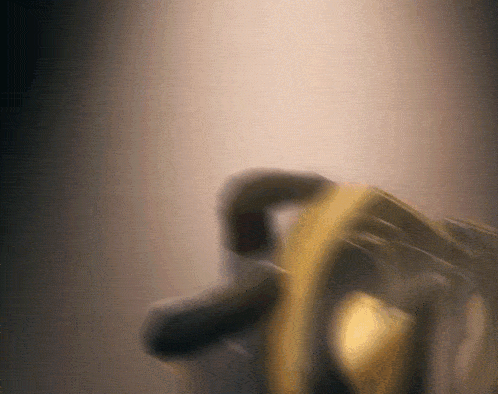 a blurry picture of a person holding a yellow object in a dark room .