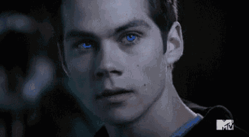 a close up of a young man with blue eyes .