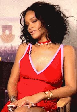 a woman in a red dress is sitting in a chair with her eyes closed