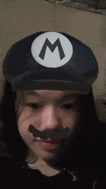 a girl wearing a hat with a white m on it