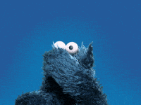 cookie monster from sesame street reaching up into the sky
