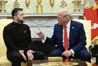 two men are sitting on a couch and one of them is wearing a shirt that says ukraine on it