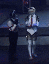 two robots are standing next to each other in a room .