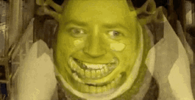 a man with braces on his teeth is smiling like shrek from shrek .