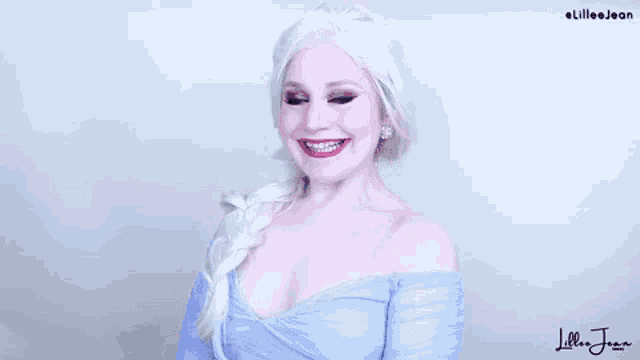 a woman dressed as elsa from frozen is making a funny face with her mouth open .