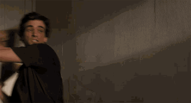 a blurry picture of a man holding a yellow object in his hand .