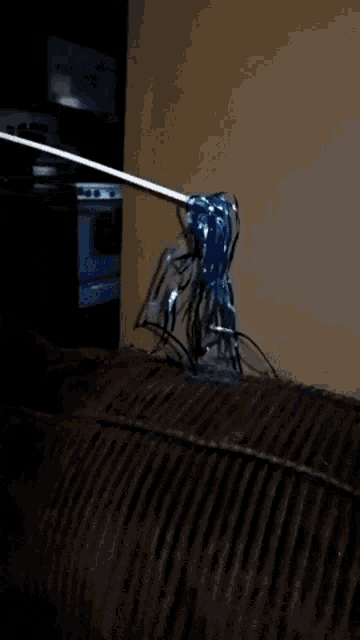 a blue balloon is sitting on a couch