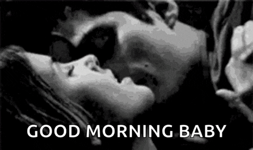 a black and white photo of a man and woman kissing with the words `` good morning baby '' .