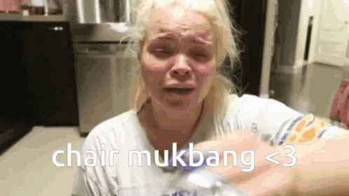 a woman is crying in a kitchen and the words chair mukbang < 3 are on the screen