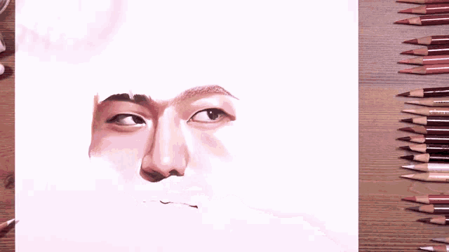 a person is drawing a face with a colored pencil