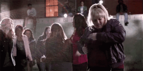 a group of women are standing next to each other in a dark room .