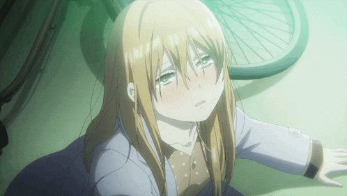 a girl with long blonde hair and green eyes is crying in front of a bicycle wheel