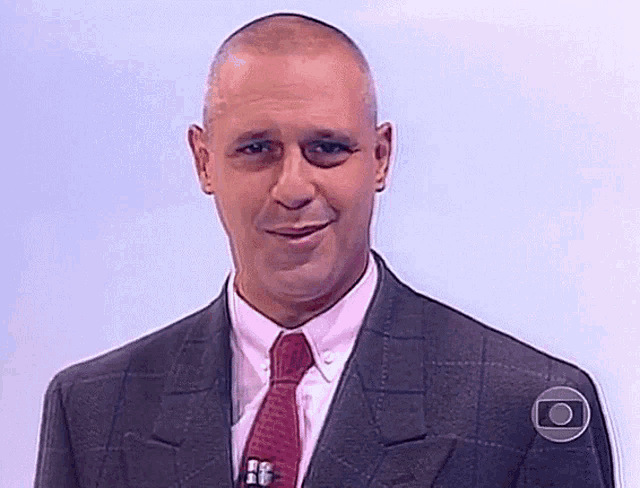 a man in a suit and tie with a circle around his neck that says o