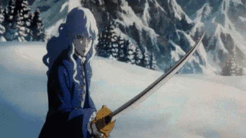 a man is holding a sword in the snow in front of mountains .