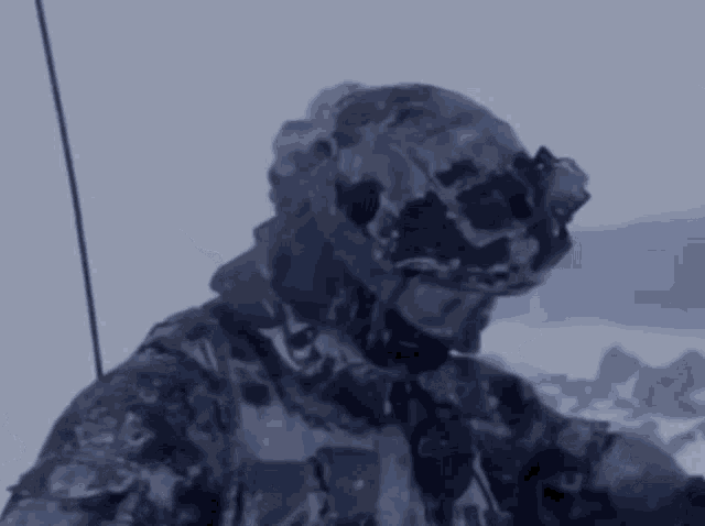 a soldier wearing a helmet and goggles is in the snow