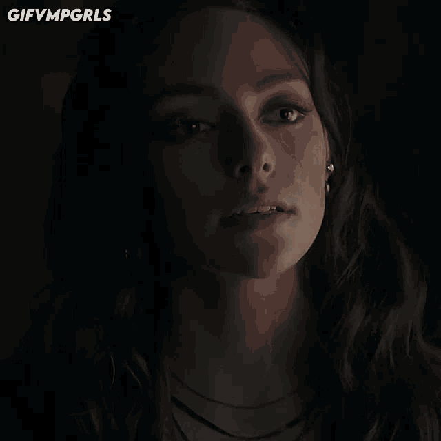 a close up of a woman 's face with gifvmpgrls written on the bottom
