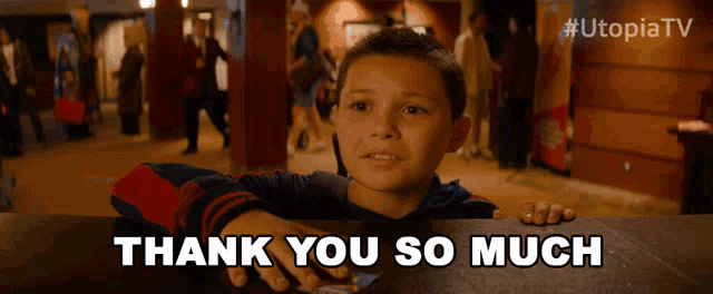 a young boy says thank you so much in front of a sign that says utopia tv
