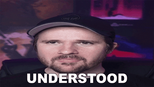 a man with a beard is wearing a hat and the word understood is on his face