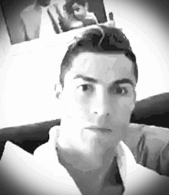 a black and white photo of a man taking a selfie