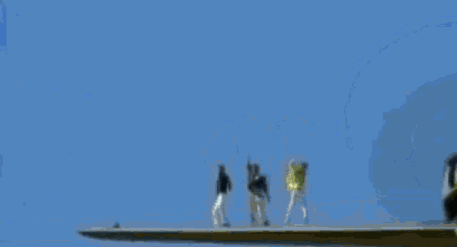 a blurry picture of a man wearing sunglasses standing next to another man