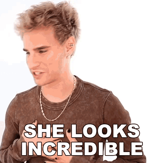 a man wearing a brown shirt with the words she looks incredible