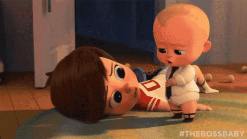 a baby from the boss baby is laying on the floor next to a boy