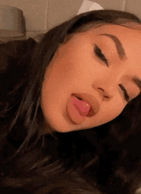 a woman sticking her tongue out in a close up